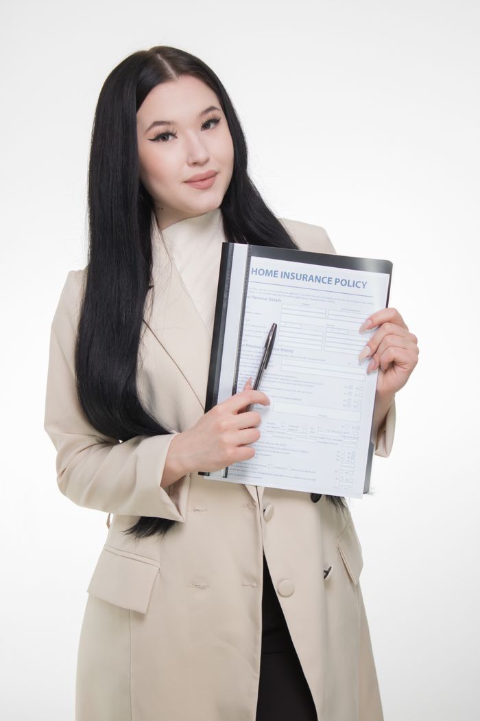 Services Professional businesswoman presenting a home insurance policy with confidence.